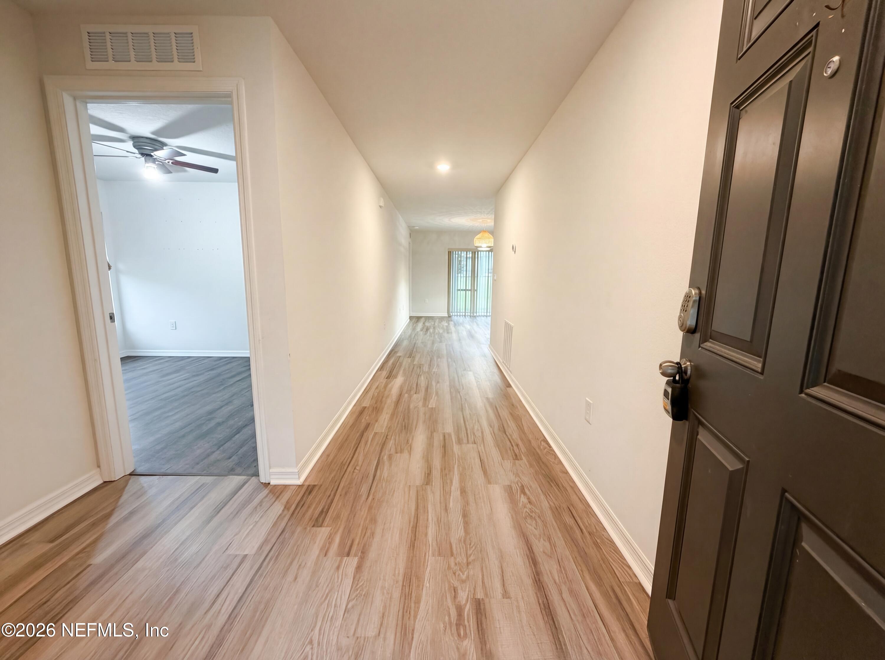 171 River Ridge Welaka, FL 32193 - Photo 7 of 17 a view of a hallway with wooden floor and staircase