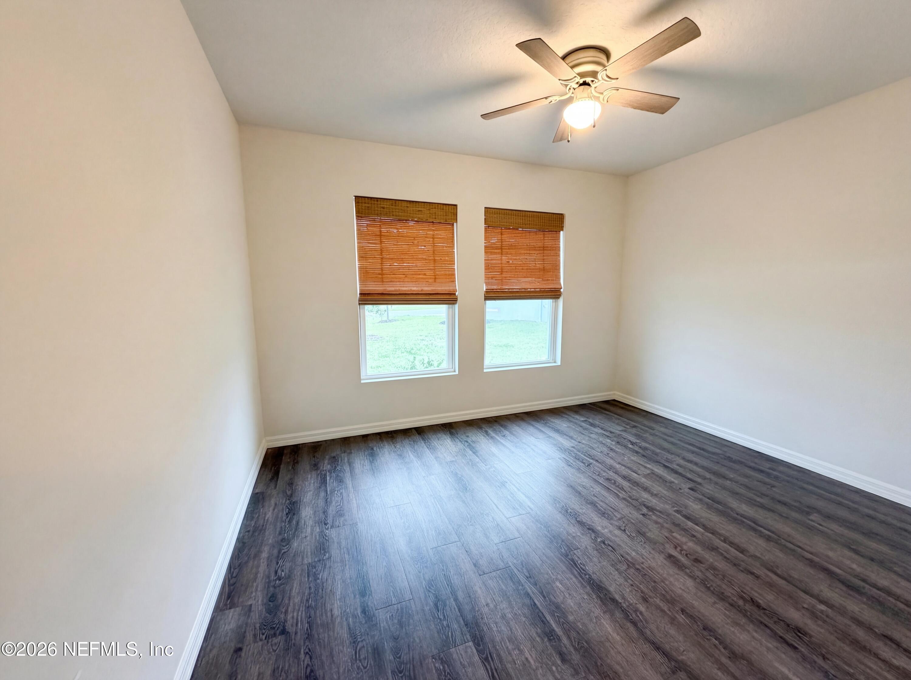 171 River Ridge Welaka, FL 32193 - Photo 8 of 17 wooden floor in an empty room with a window