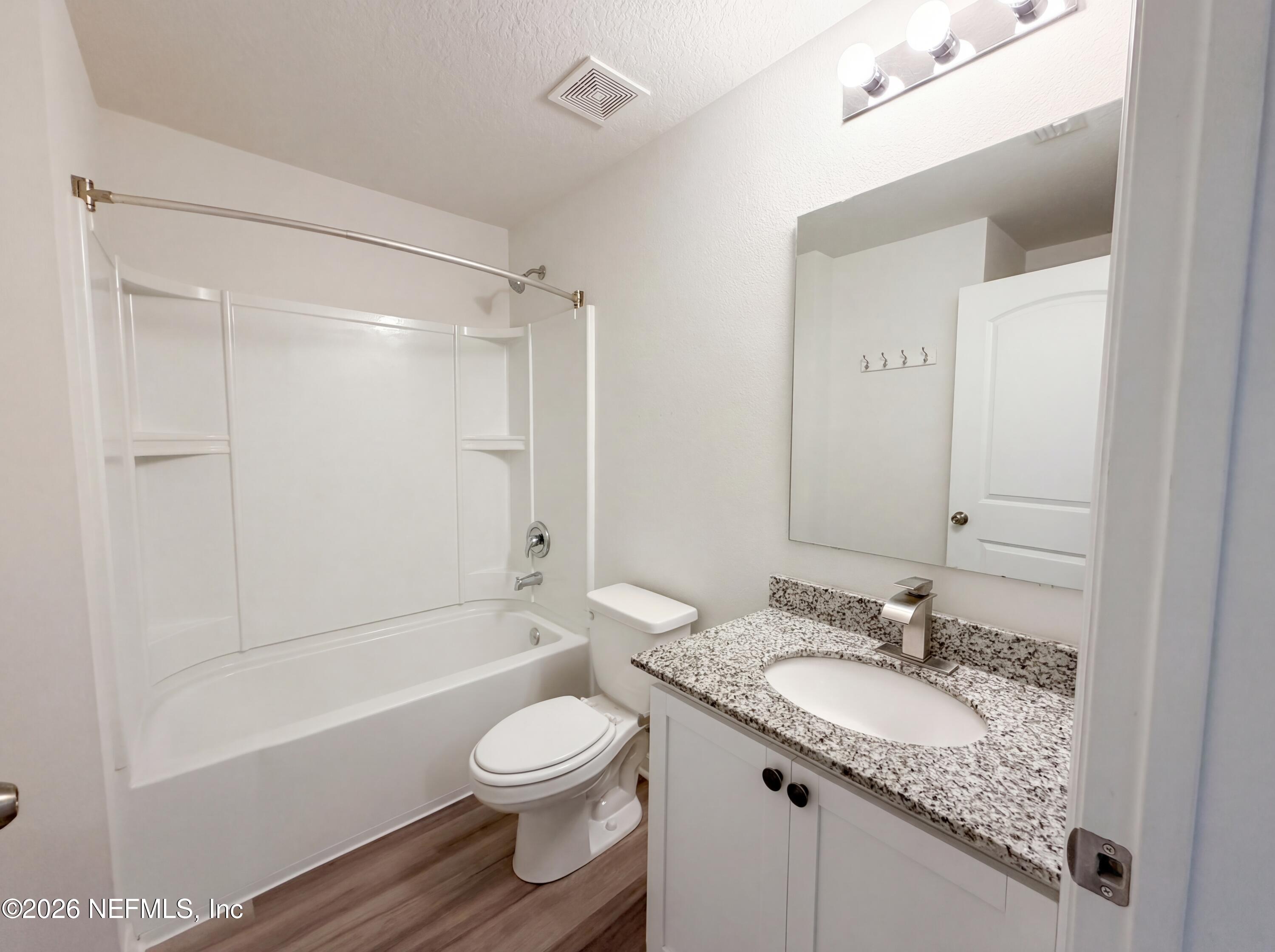 171 River Ridge Welaka, FL 32193 - Photo 9 of 17 a bathroom with a granite countertop sink toilet and shower