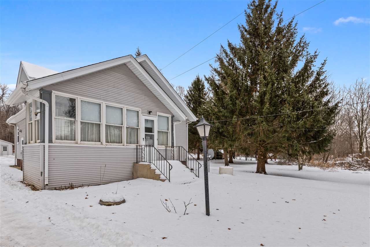 3202 Prairie Road Rockford, IL 61102 - Photo 1 of 21 a front view of a house with a yard covered with snow