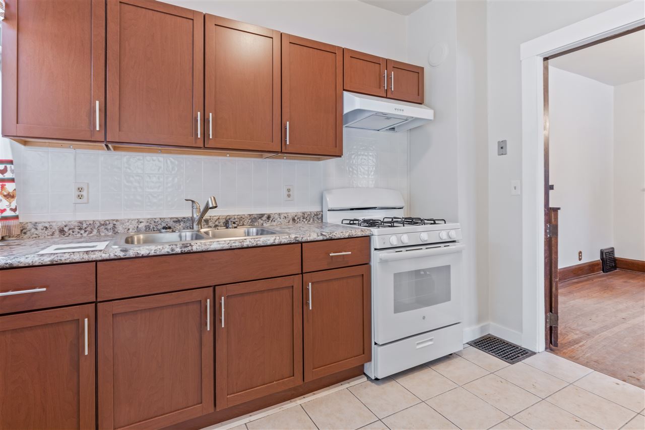 3202 Prairie Road Rockford, IL 61102 - Photo 4 of 21 a kitchen with granite countertop cabinets and white appliances
