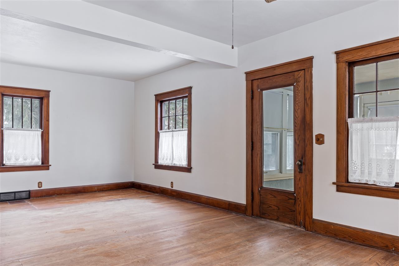 3202 Prairie Road Rockford, IL 61102 - Photo 9 of 21 an empty room with wooden floor and windows