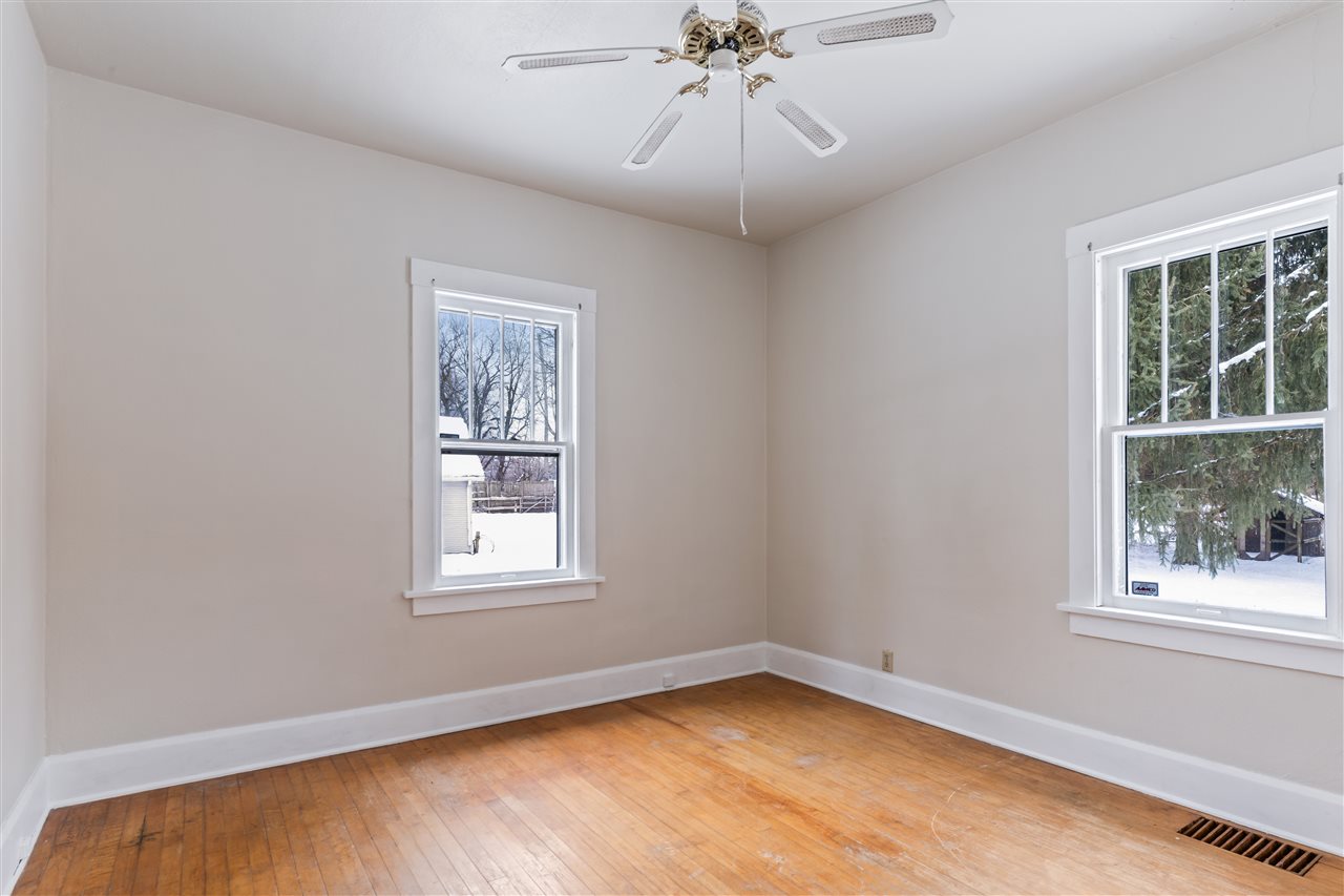 3202 Prairie Road Rockford, IL 61102 - Photo 10 of 21 a view of an empty room with a window and wooden floor