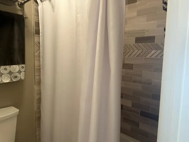 a bathroom with a shower curtain