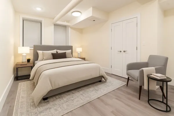 a bedroom with a bed and a chair