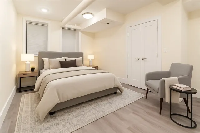 a bedroom with a bed and a chair