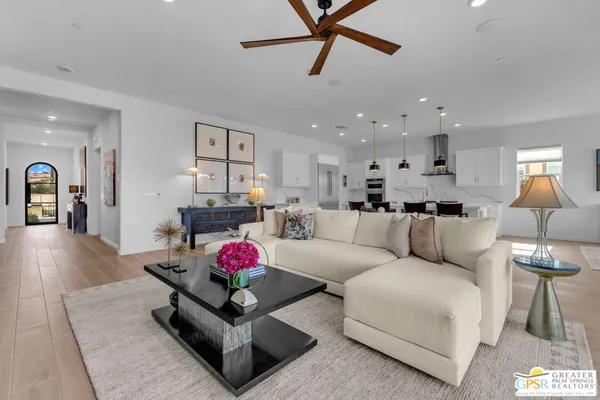 a spacious bedroom with a bed a couch and a window