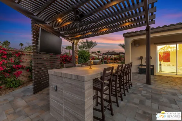 a view of a chairs and tables in the back yard of the house
