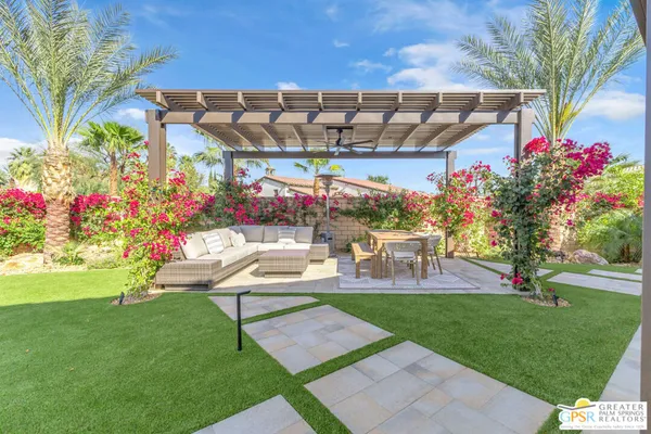 a swimming pool with outdoor seating and yard