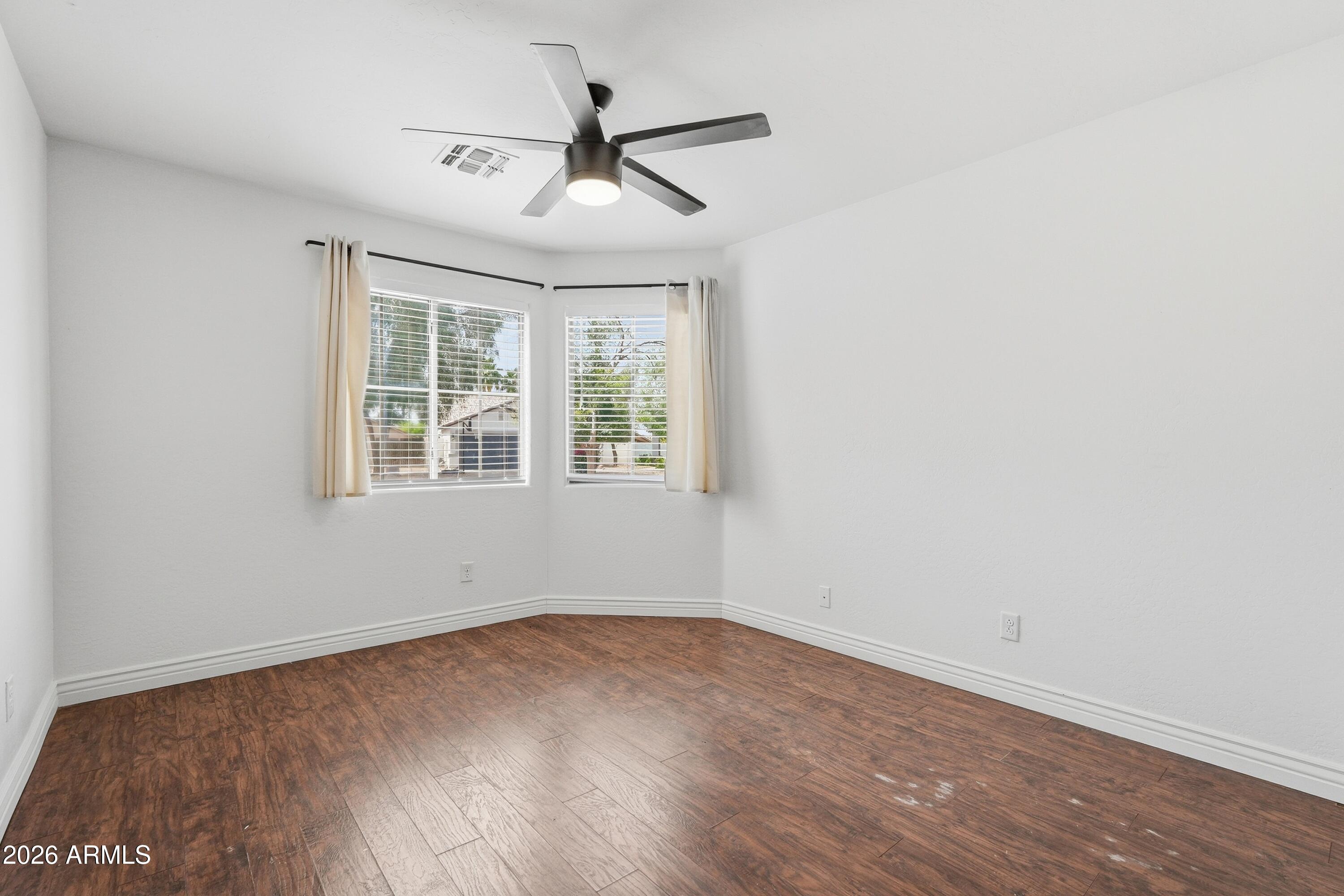 3242 East Bonanza Road Gilbert, AZ 85297 - Photo 21 of 36 an empty room with wooden floor and windows