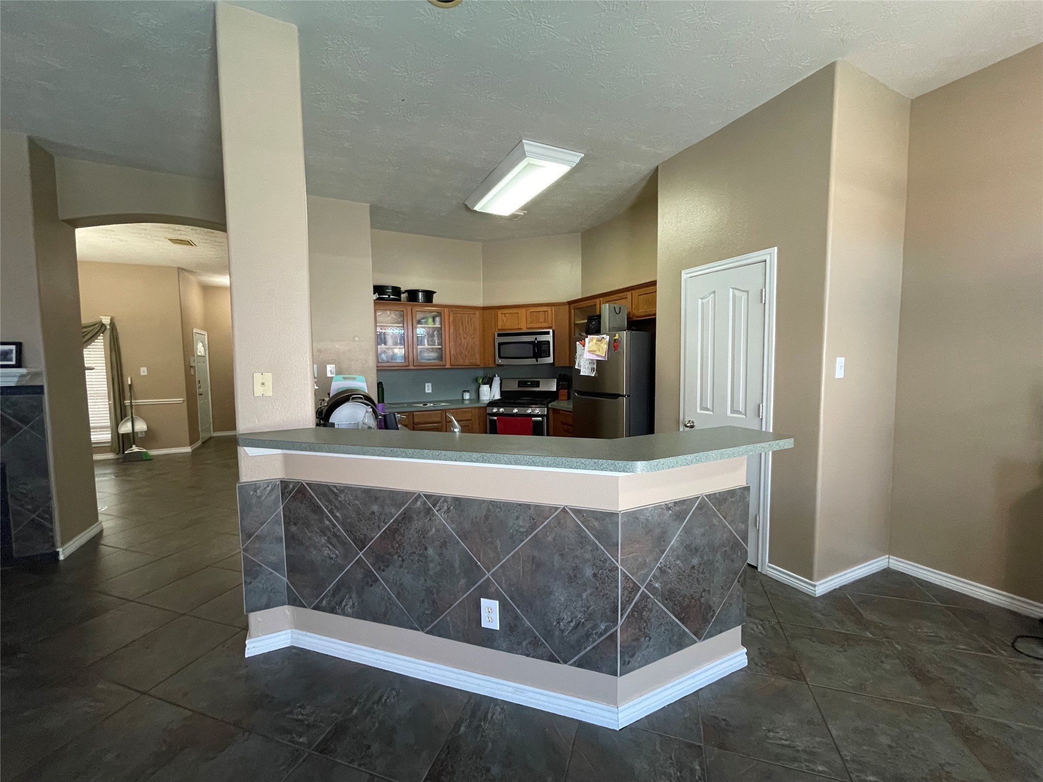22911 Sebastian Drive Porter, TX 77365 - Photo 2 of 10 a kitchen with a sink and a stove top oven