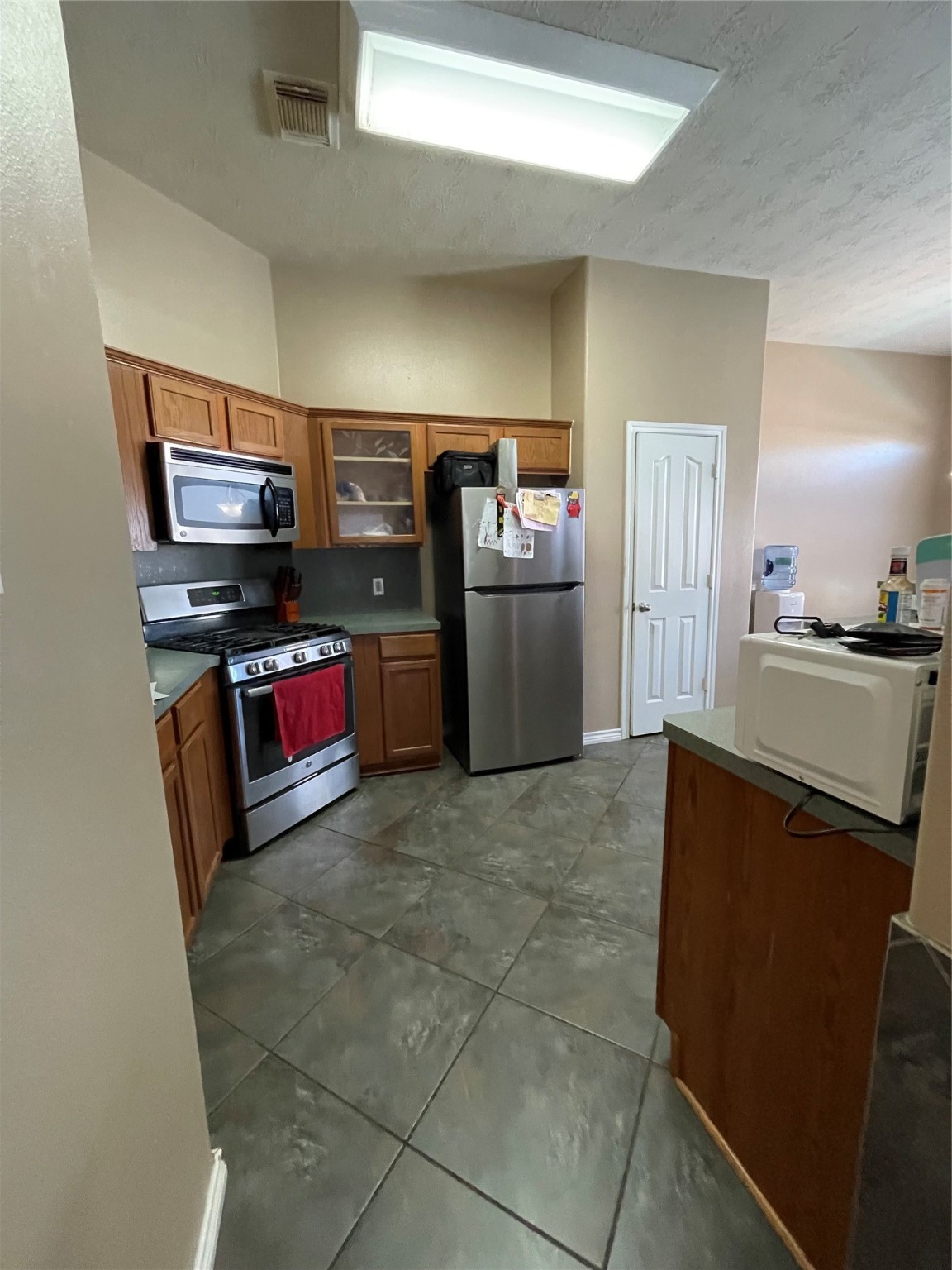 22911 Sebastian Drive Porter, TX 77365 - Photo 4 of 10 a kitchen with stainless steel appliances granite countertop a refrigerator and a stove