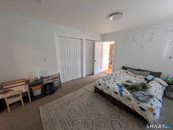 a bedroom with furniture and a window
