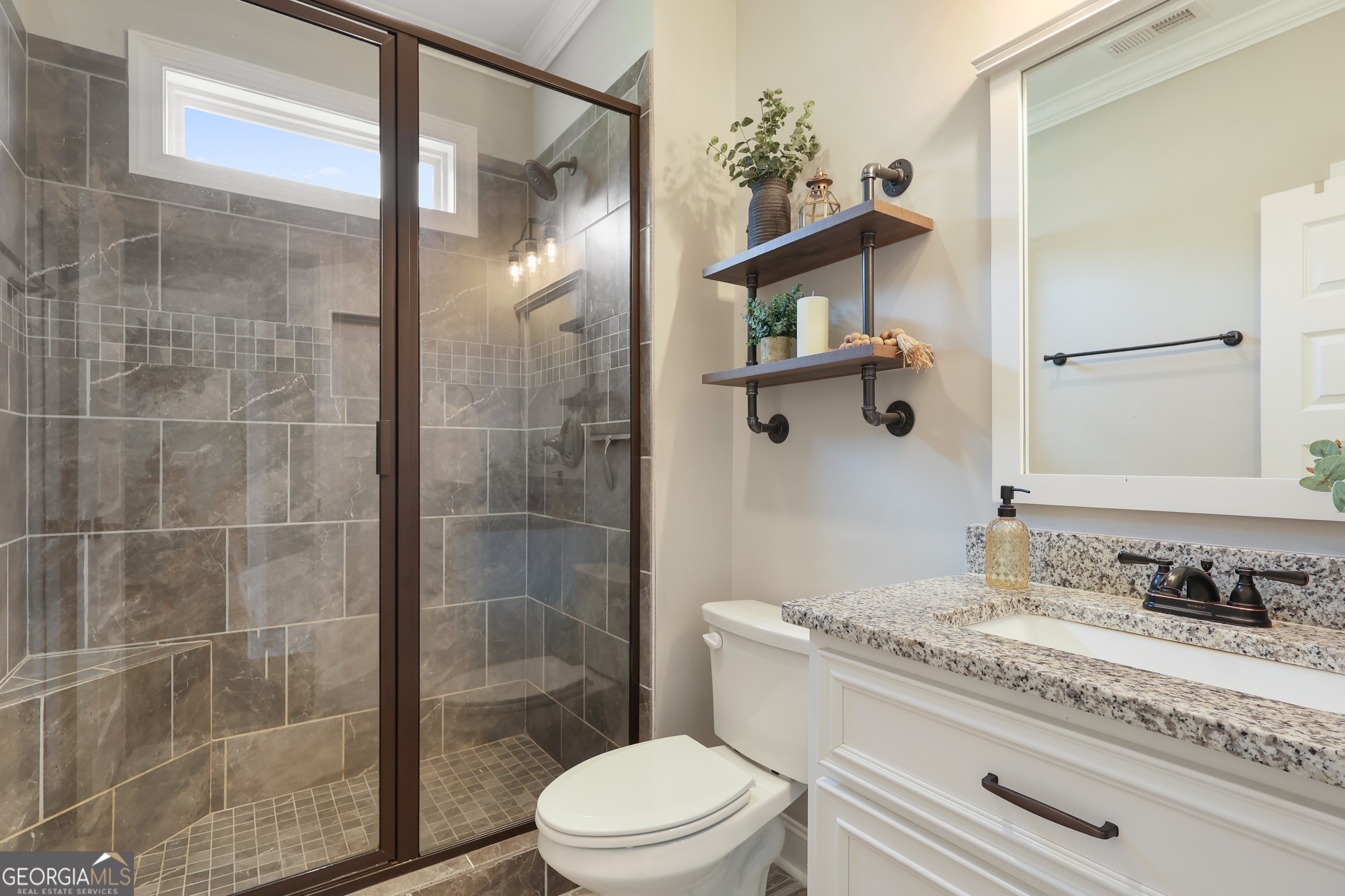 89 Claire Road Forsyth, GA 31029 - Photo 6 of 40 a bathroom with a granite countertop sink a toilet and shower