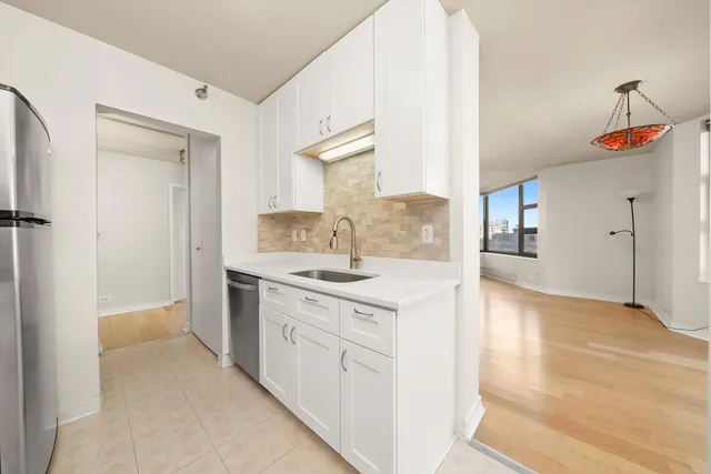 a kitchen with a stove a sink and a refrigerator