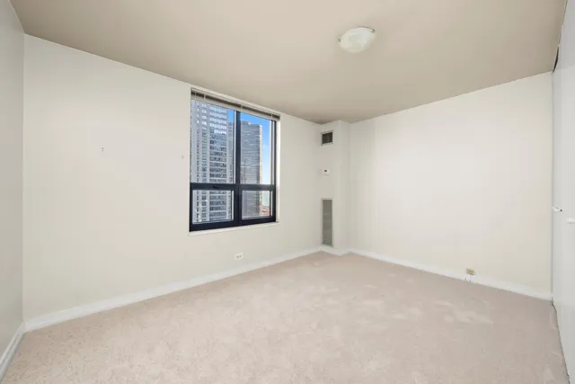 an empty room with windows and closet