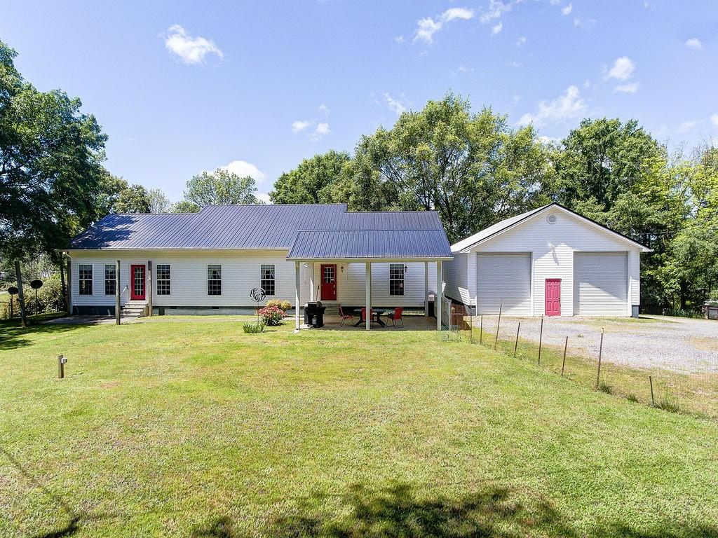 960 McEntyre Loop Calhoun, GA 30701 - Photo 1 of 1 a front view of a house with a garden and porch