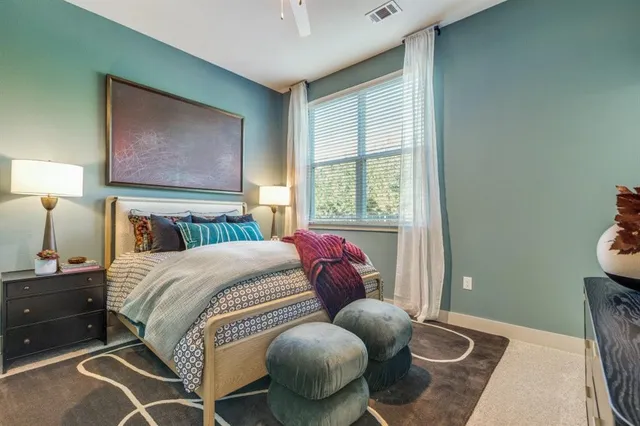 a bedroom with a bed and window