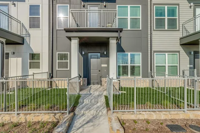 a view of a house with a small deck and a large window