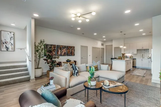 a living room with furniture and kitchen view