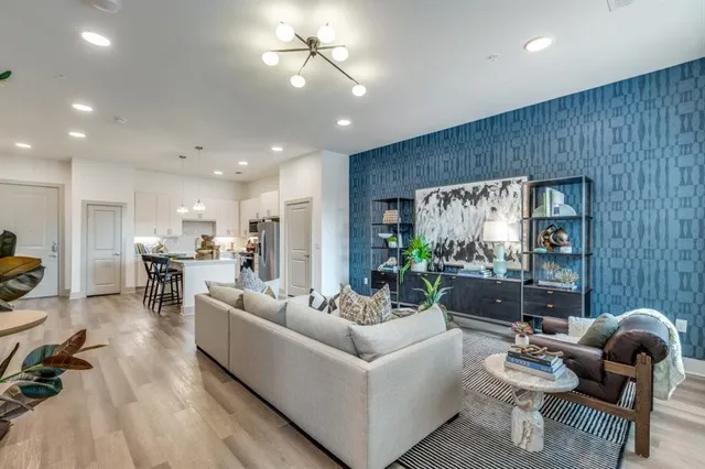 a living room with furniture and wooden floor