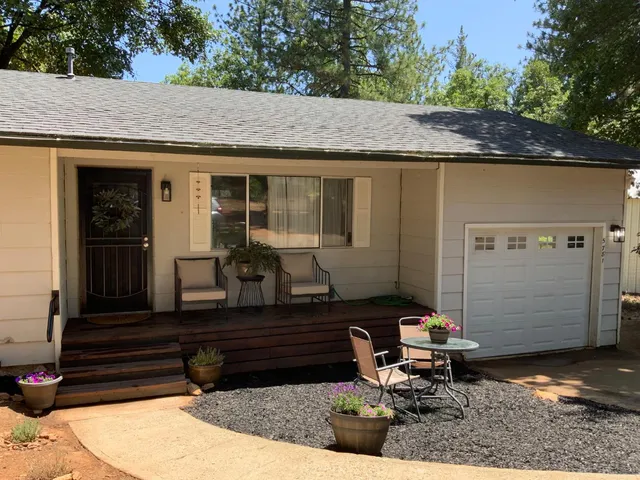 a front view of a house with sitting area