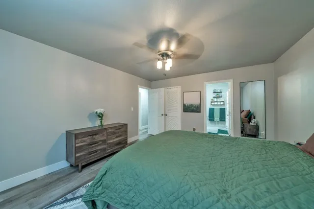 a view of a room with gym equipment and a chandelier