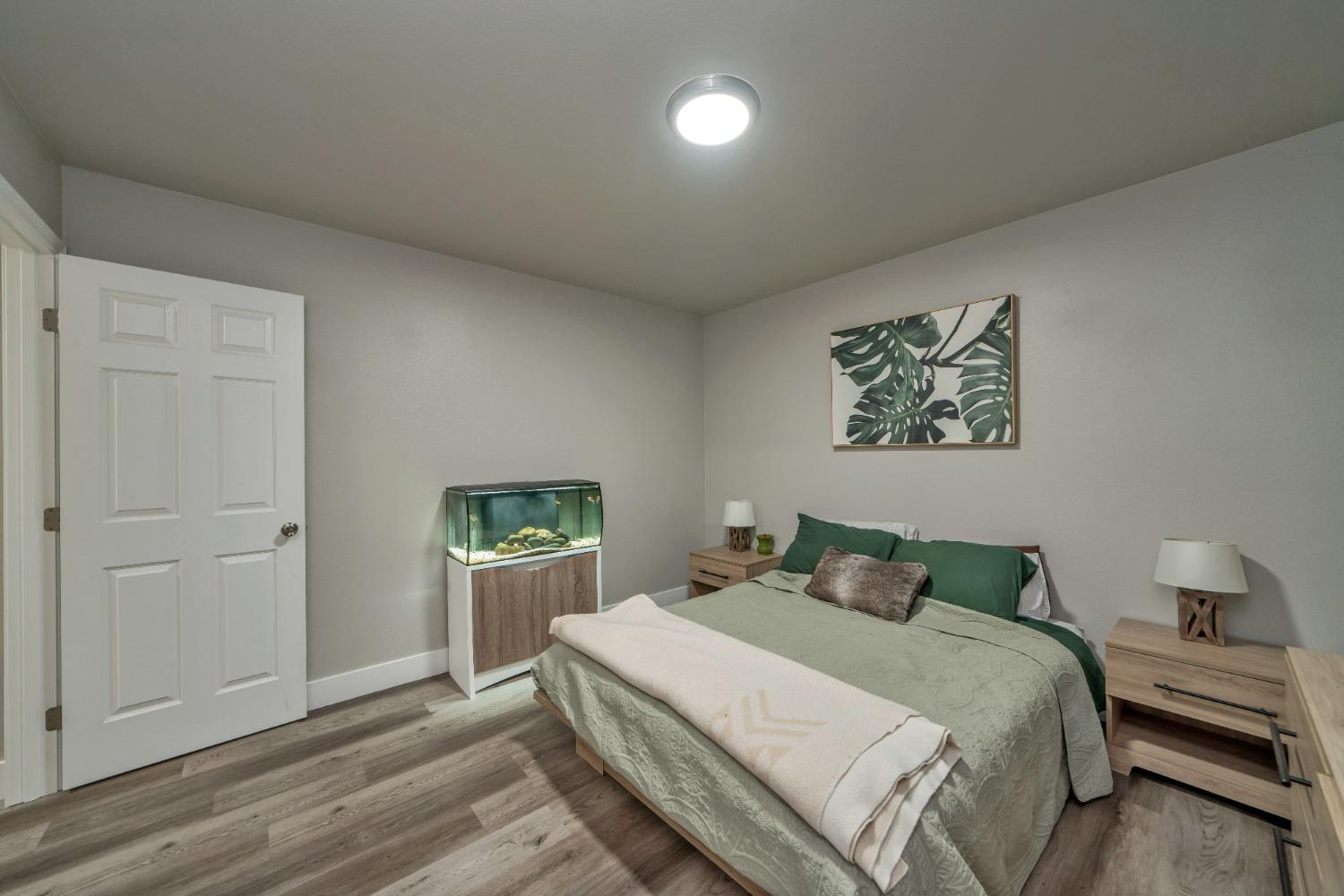 5781 Sly Park Road Pollock Pines, CA 95726 - Photo 14 of 40 a bedroom with a bed and a painting on the wall