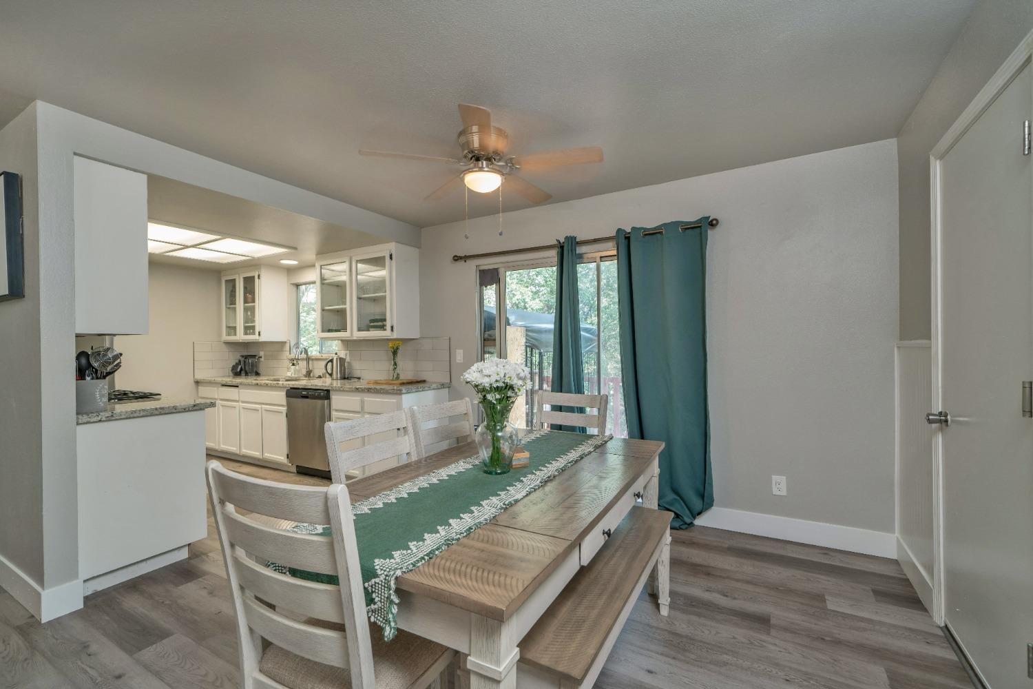 5781 Sly Park Road Pollock Pines, CA 95726 - Photo 18 of 40 a large white kitchen with sink and wooden floor