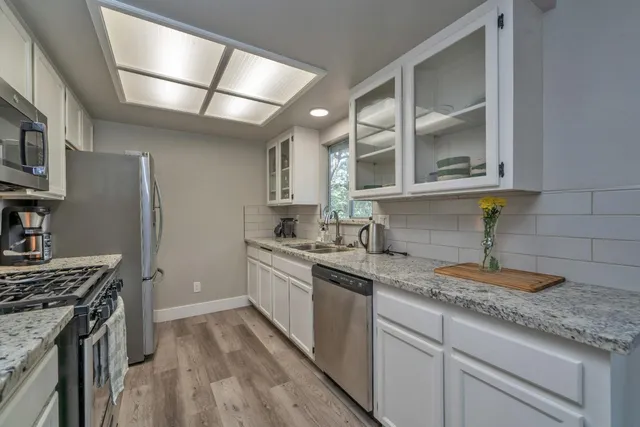 a kitchen with a sink stove and cabinets
