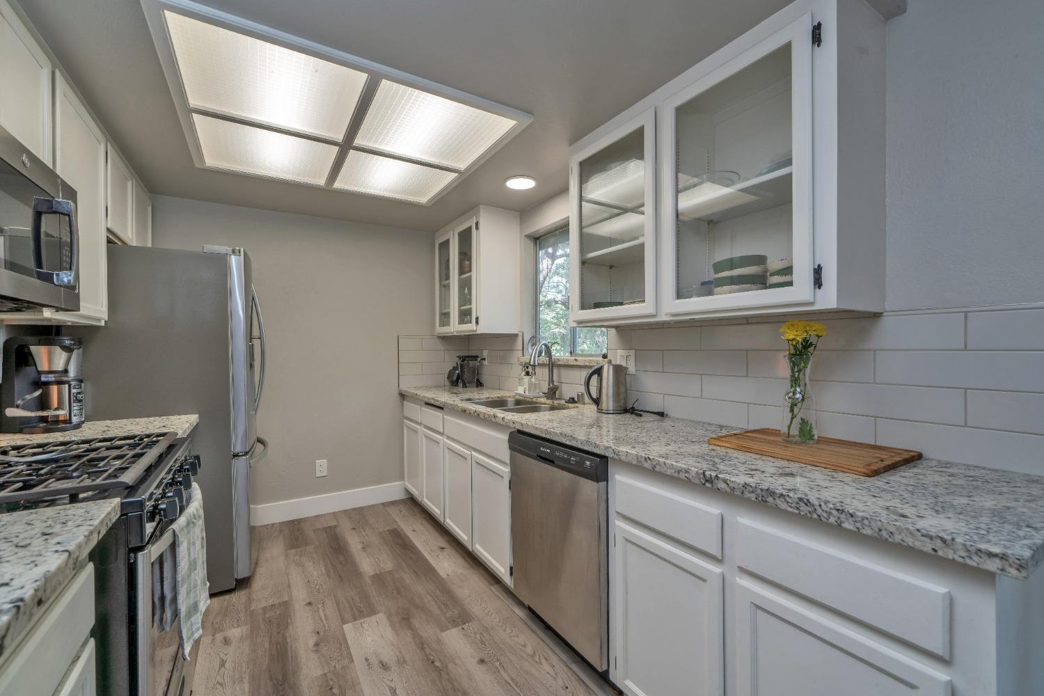 5781 Sly Park Road Pollock Pines, CA 95726 - Photo 2 of 40 a kitchen with a sink stove and cabinets