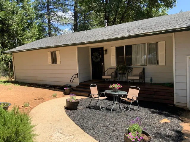 a view of a backyard with chairs and a patio