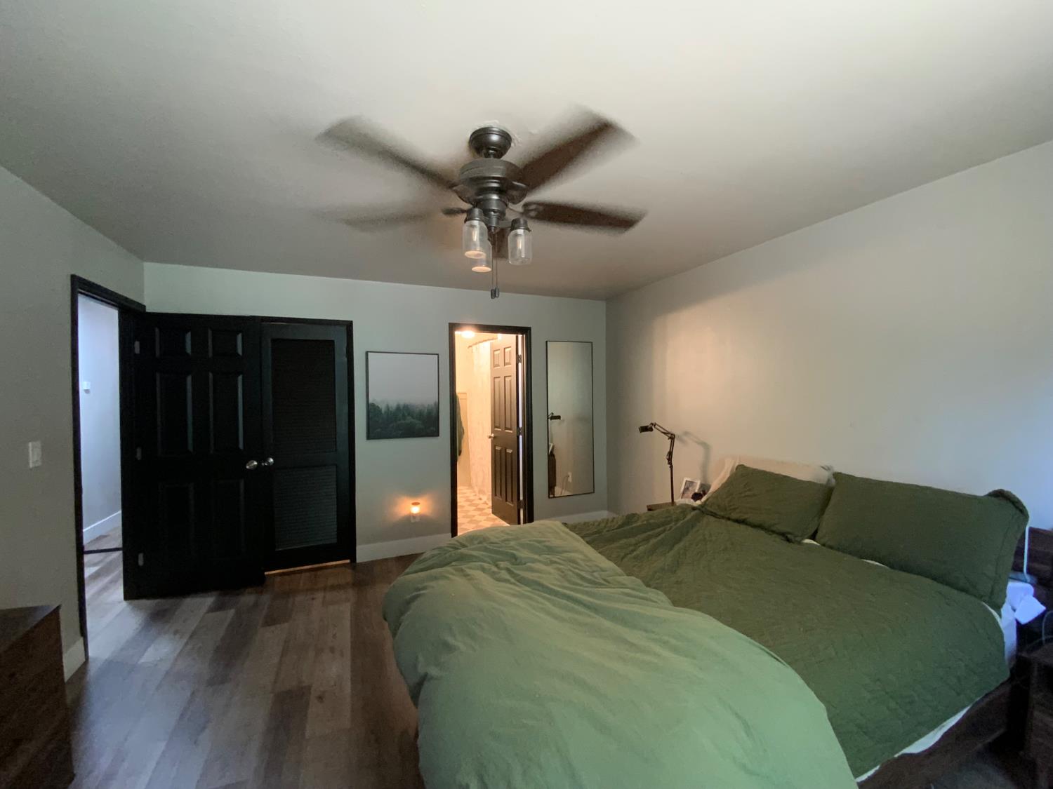 5781 Sly Park Road Pollock Pines, CA 95726 - Photo 3 of 40 a bedroom with a bed and a chandelier