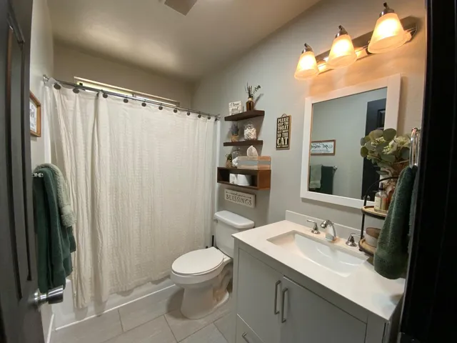 a bathroom with a sink toilet and shower