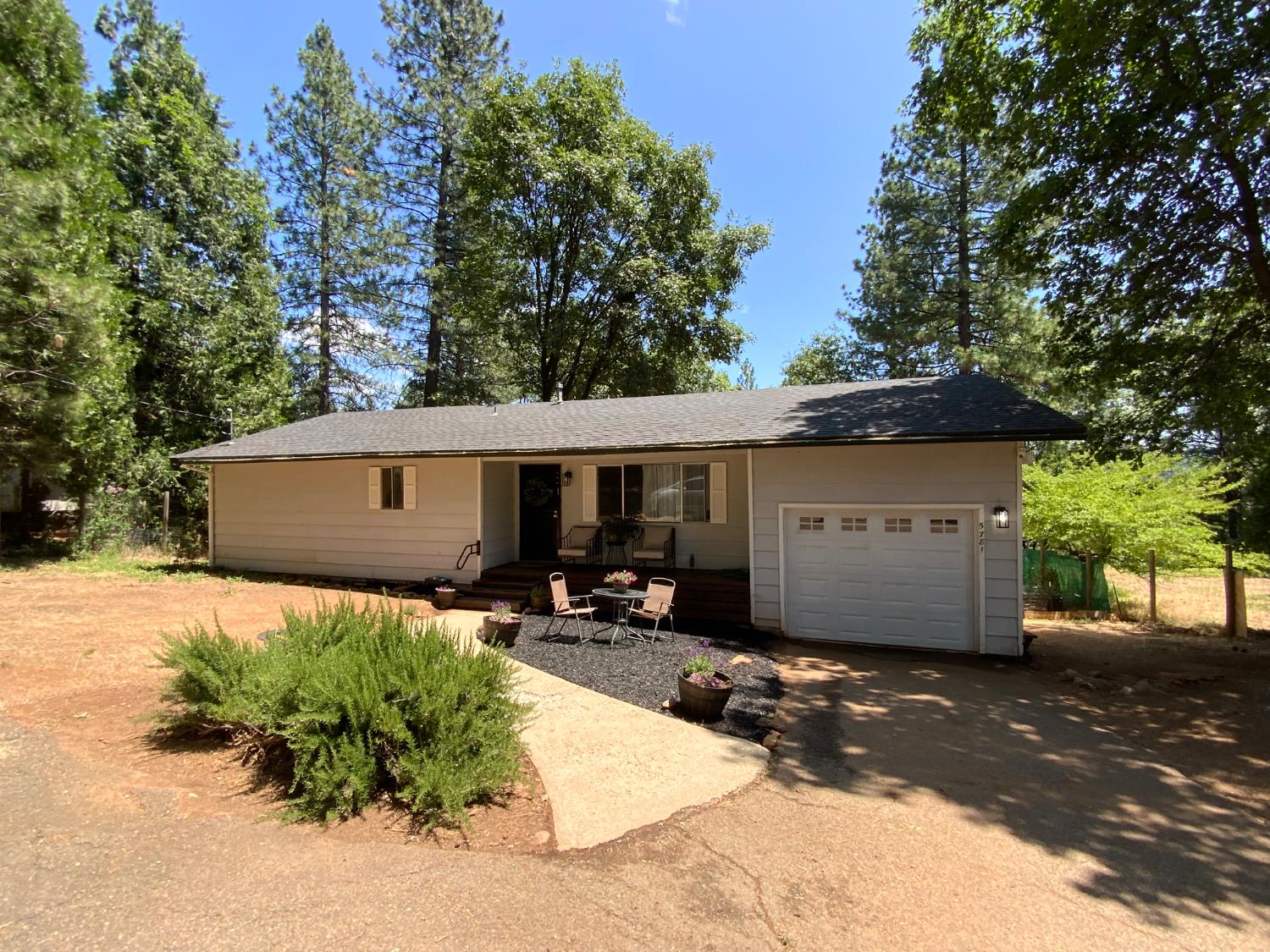 5781 Sly Park Road Pollock Pines, CA 95726 - Photo 38 of 40 a front view of a house with a yard and potted plants