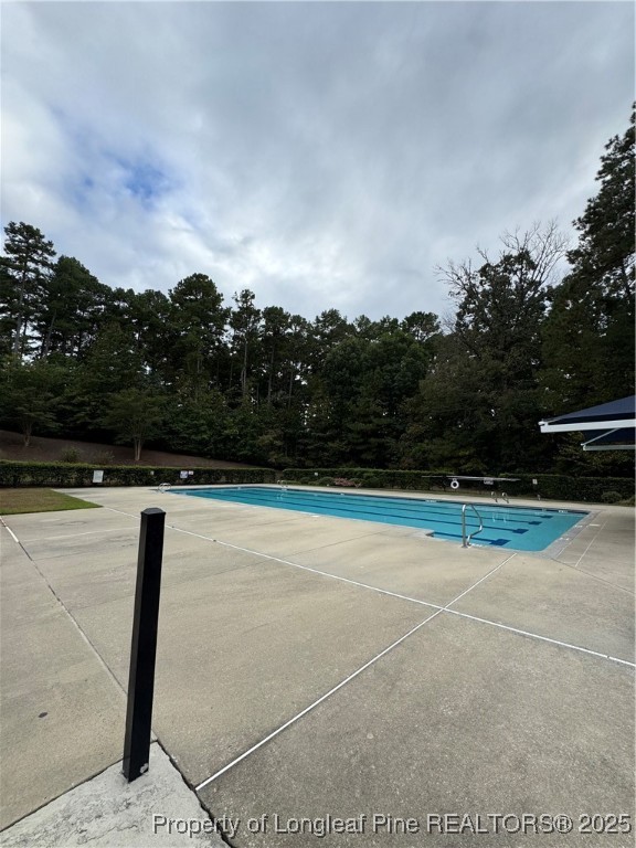 116 Higher Learning Drive Durham, NC 27713 - Photo 29 of 32 a view of swimming pool with lawn chairs and wooden fence