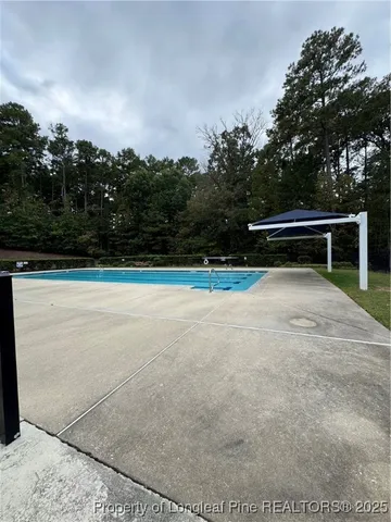a swimming pool with wooden fence