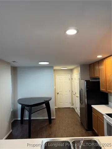 a kitchen that has a sink cabinets counter space and appliances