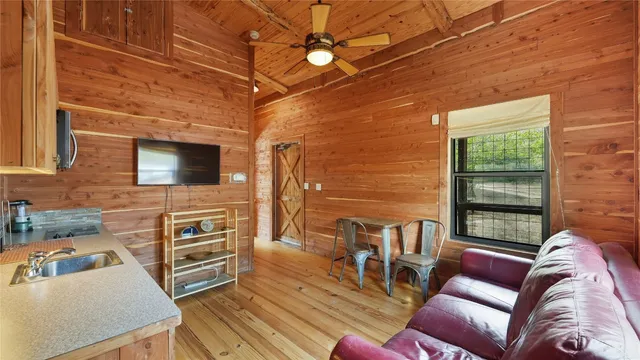 a view of a room with furniture and wooden floor