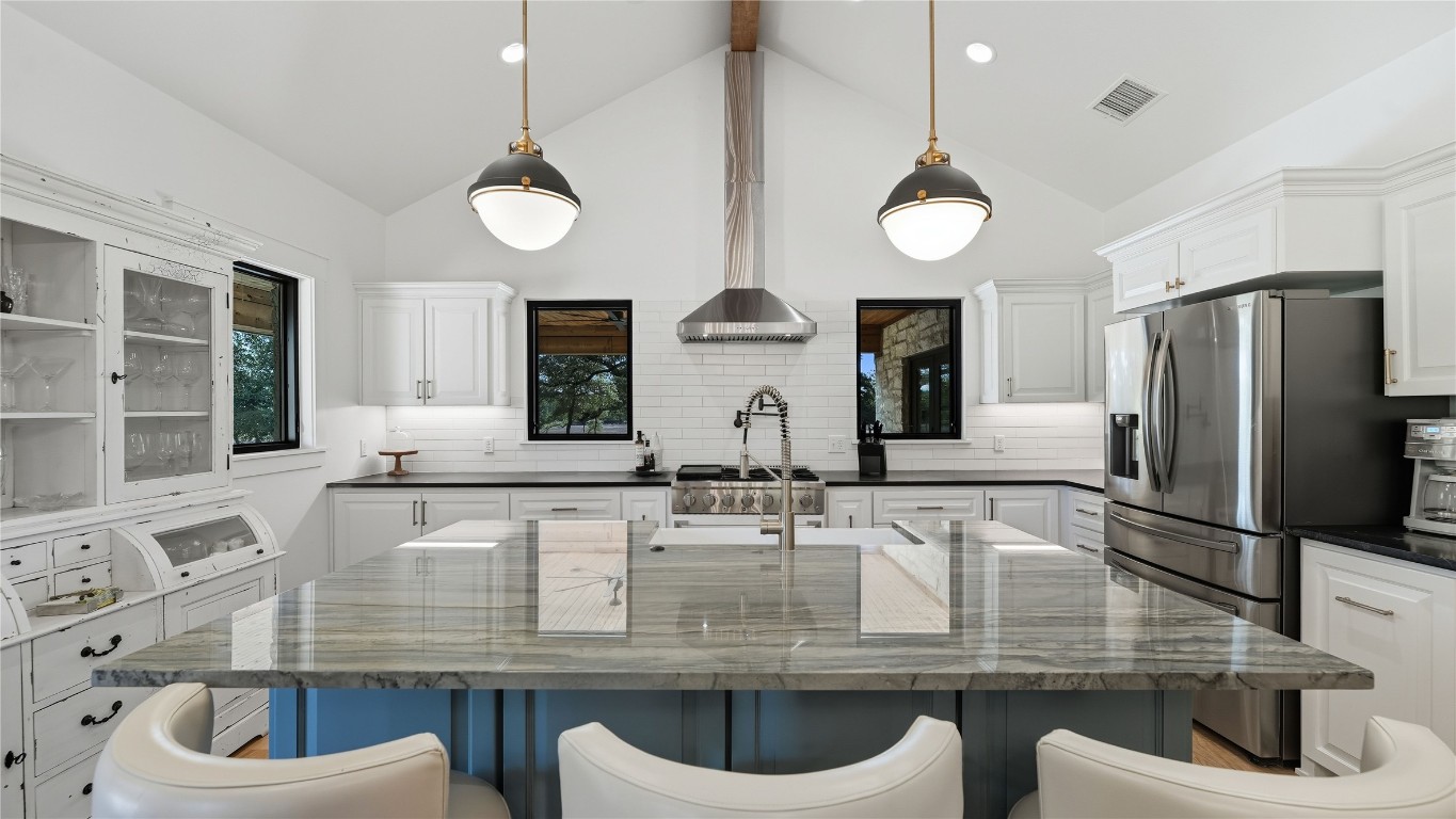 2656 River Bend Road Smithville, TX 78957 - Photo 8 of 40 a kitchen with kitchen island granite countertop a sink and a refrigerator