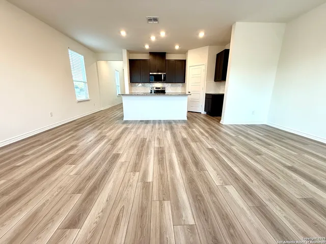 a view of kitchen with sink microwave and refrigerator