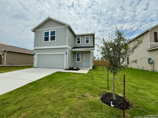 a front view of a house with a garden and yard