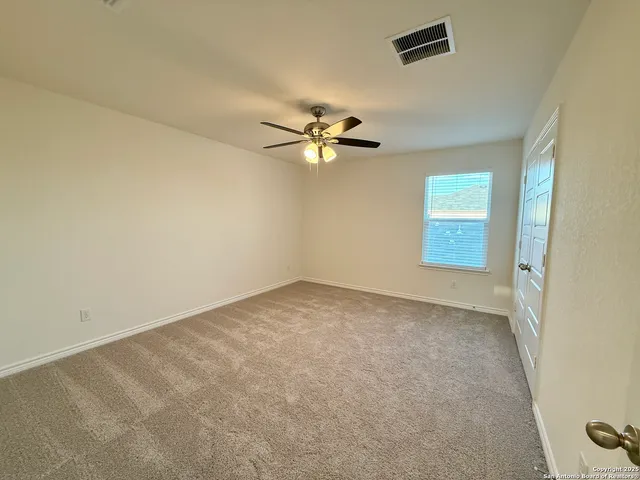 a view of a hallway with wooden floor and closet area