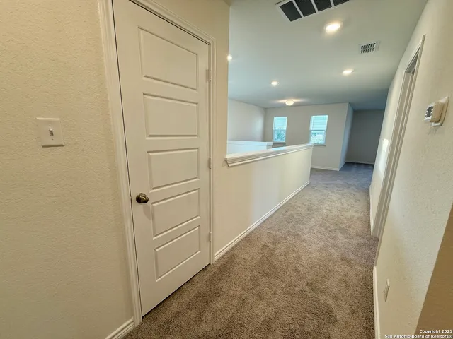 a view of a livingroom with a ceiling fan and window