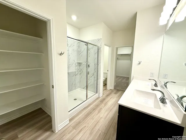 a bathroom with a sink vanity and a mirror
