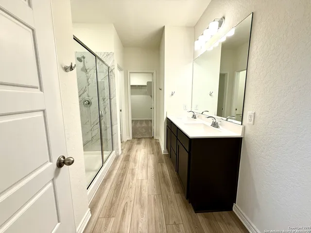 a spacious bathroom with a sink mirror and a shower