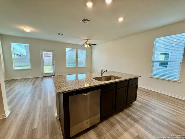 a spacious bathroom with a granite countertop sink