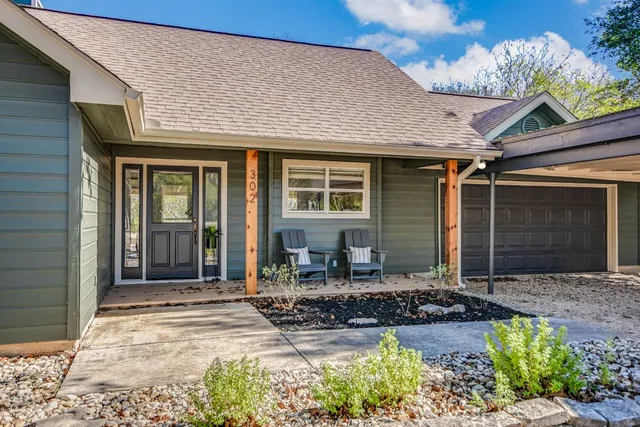 a front view of a house with garden