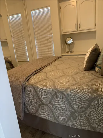 a bedroom with a bed and cabinets