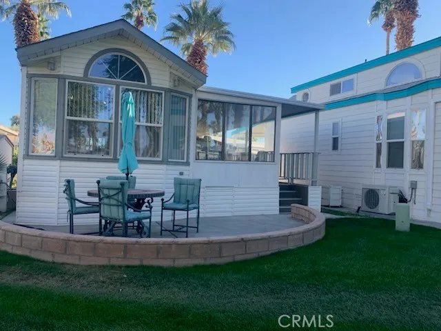a front view of a house with patio and garden